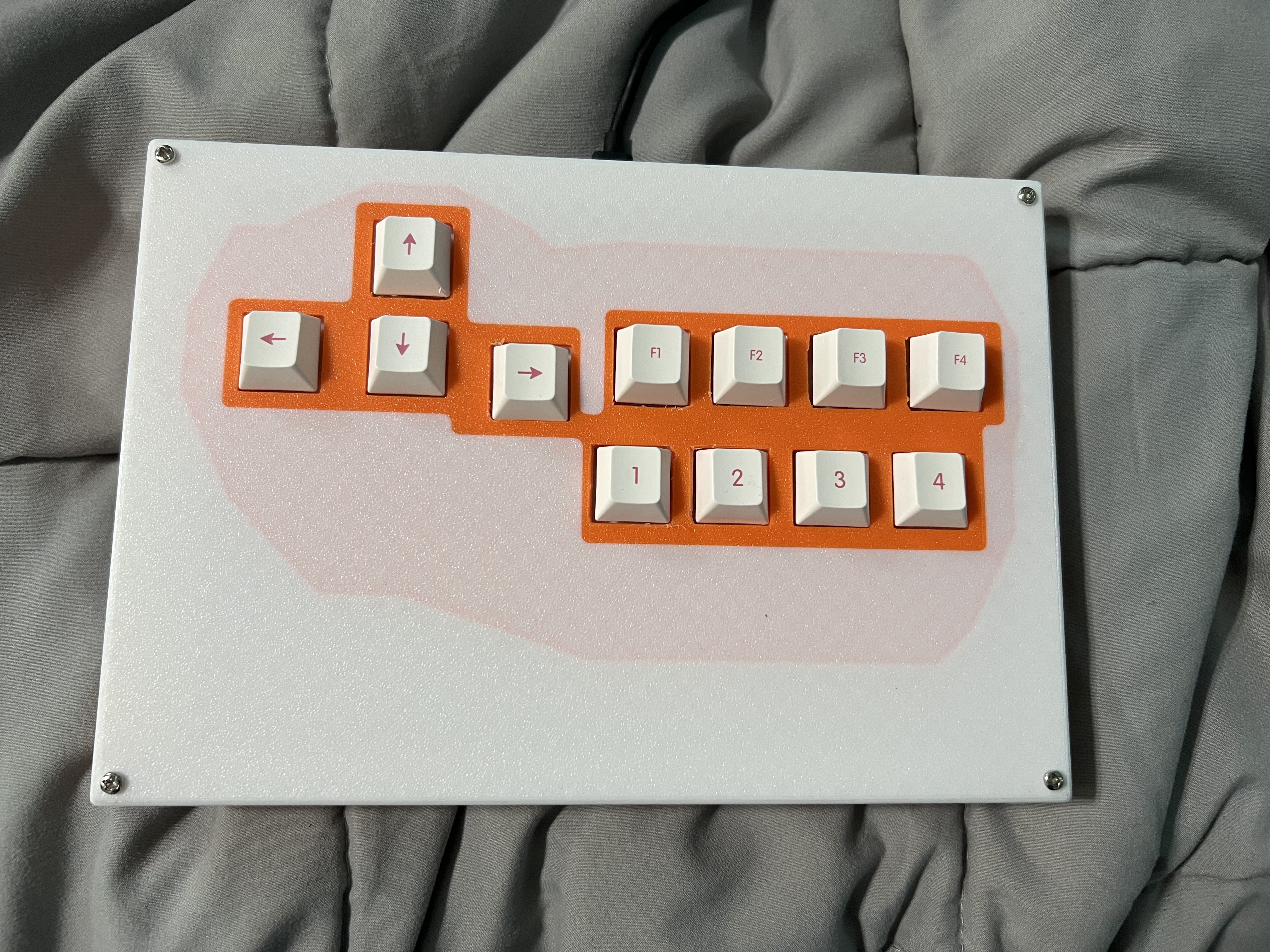 A 3d printed hitbox flat controller that is orange and white